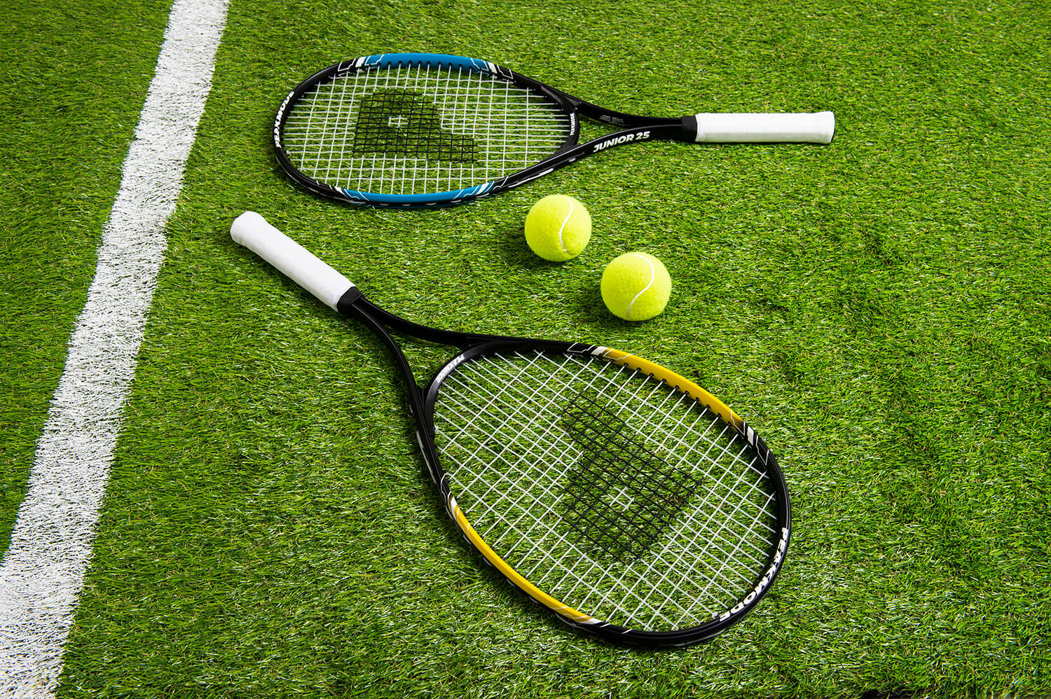 Product photography of tennis rackets on grass