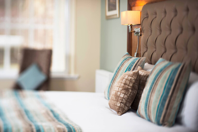 Lifestyle shot of bed at New Lanark Hotel by Edinburgh Hospitality and leisurel photographers blink imaging
